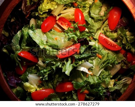 Mixed Greens Salad with Grape Tomatoes in Wooden Bowl