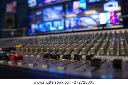 Audio mixer at a television station, shallow depth of field/On AIR/Mixing news