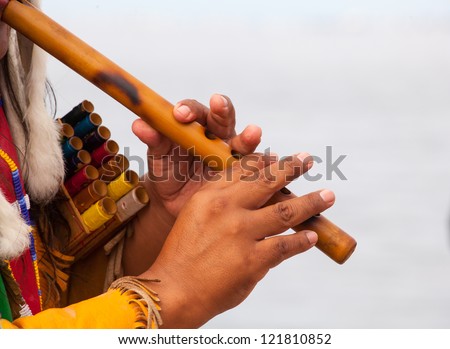 Peruvian Man In Native Costume Playing flute