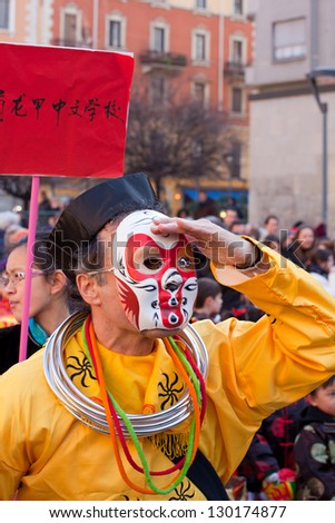 MILAN, ITALY - FEBRUARY 10: Undefined man with mask looking the chinese new year parade in Milan on February 10, 2013