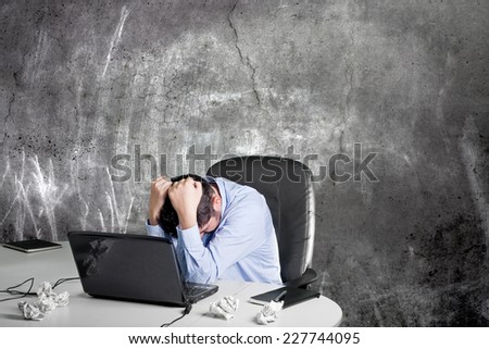Frustrated businessman in his office after the financial crisis
