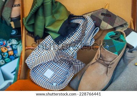 Male clothes. Shirt, scarf, shoes and bow tie in the clothes shop