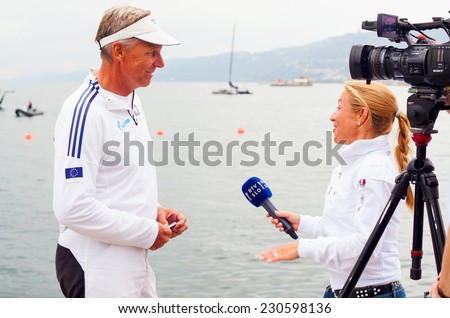 TRIESTE, ITALY - OCTOBER, 12: The journalist of the Slovenian tv, RTV interviewing Jochen Schuman skipper of the Esimit Europa 2, sailboat winner of  the 46 th Barcolana on October 12, 2014