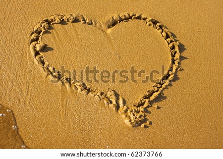 Drawing an Heart in the beach