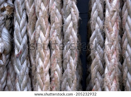 Close up of frayed old hanging ropes