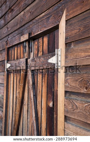 Wooden double doors in a wood wall