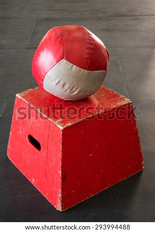 Red jump box with a red and gray medicine ball