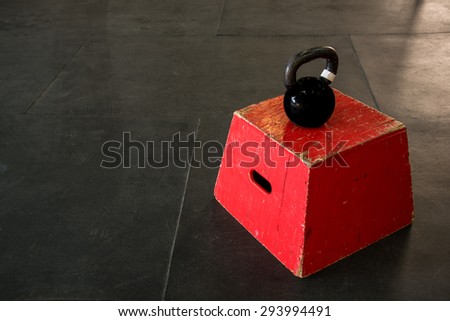 Red jump box with a black kettle bell