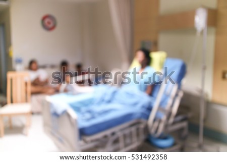 Blurred background  Patients broken leg lying on the bed in  hospital room .