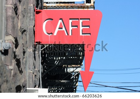 Red cafe sign with an arrow