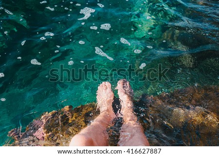 Two feet dipping  in water.Foot spa