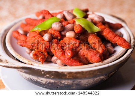 butter chicken claw and peanuts on white plate