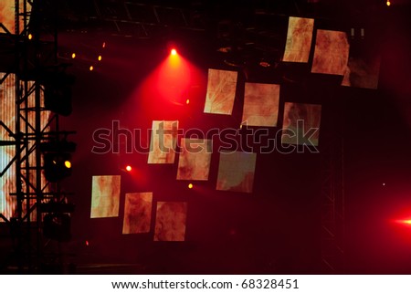 Image of red stage lights, thick fog creates drama