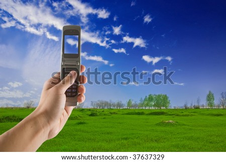 man taking photo with mobile cell phone - landscape orientation