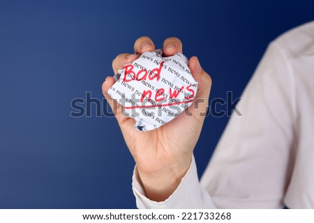 Crumpled paper ball with red words 
