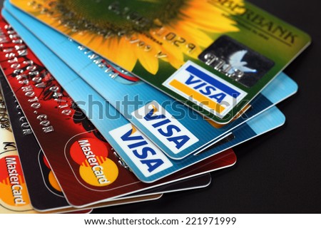 Tambov, Russian Federation - September 11, 2012: Heap of credit cards with Visa and Mastercard logos on black background. Studio shot.