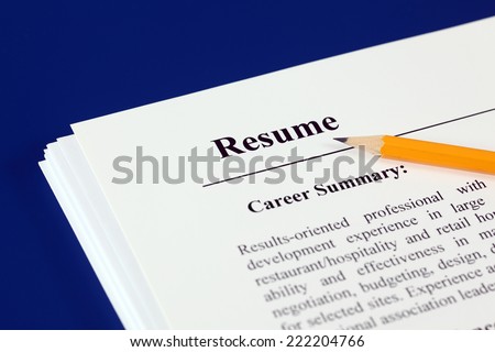 Stack of resumes with pencil on a blue background.