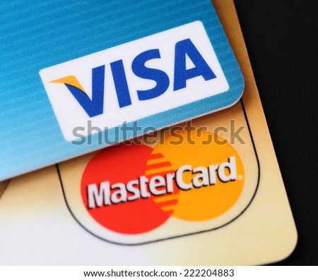 Tambov, Russian Federation - September 11, 2012: Visa and Mastercard logos on credit cards. Black background. Studio shot. Visa and Mastercard are a two biggest credit card companies in the world.