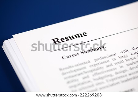 Stack of resumes on a blue background.