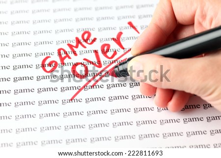 Woman\'s hand with red pen writing word \