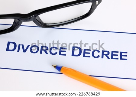 Divorce Decree with black glasses and ballpoint pen.