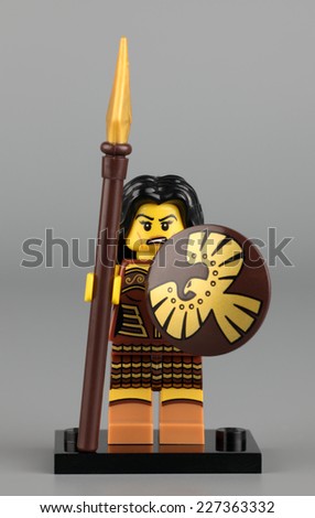 Tambov, Russian Federation - June 02, 2013: Lego Warrior Woman mini figure with lance and shield on gray background. Studio shot.