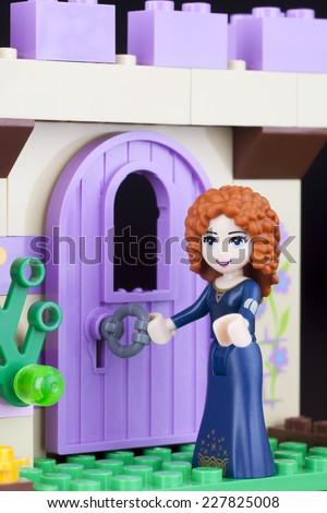 Tambov, Russian Federation -April 30, 2014: LEGO Disney Princess Merida mini figure open castles door. Studio shot. Merida is main protagonist of cartoon Brave.