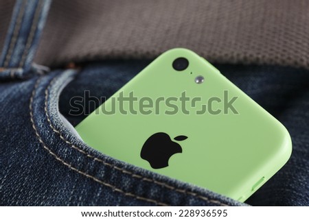 Tambov, Russian Federation - October 16, 2013: Apple iPhone 5C Green Color in a pocket of jeans. Studio shot. iPhone 5C is produced by Apple Computer, Inc.