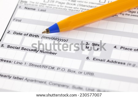 Application form with ballpoint pen. Focus on date of birth and social security number.