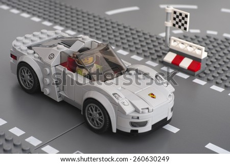 Tambov, Russian Federation - March 14, 2015 Porsche 918 Spyder by LEGO Speed Champions on the Lego road baseplates with driver inside car. Studio shot.