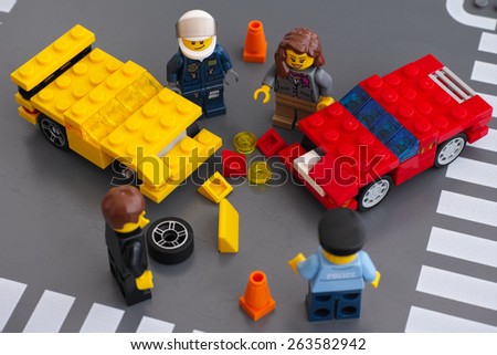 Tambov, Russian Federation - March 15, 2015 Lego car accident scene. Two custom cars crashed on the road with drivers and police officers minifigures. Car made by my 5 years son. Studio shot.