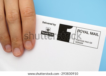 Tambov, Russian Federation - June 01, 2015 Royal Mail envelope in human hand. Studio shot.