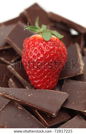 Strawberry and pieces of chocolate. White background.