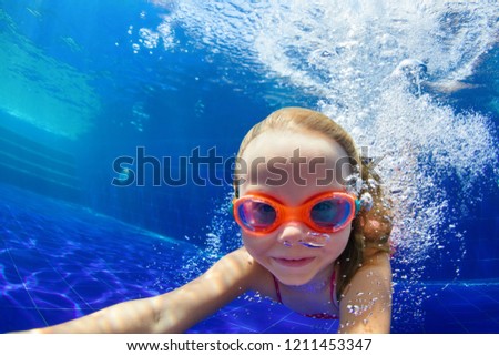 Happy family in swimming pool. Smiling child in goggles swim, dive in pool with fun - jump deep down underwater. Healthy lifestyle, people water sport activity, swimming lessons on holidays with kids