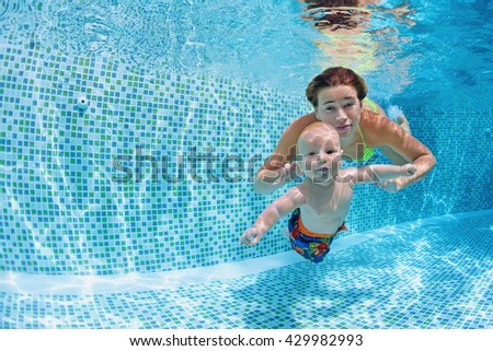 Child swimming lesson - baby with mother learn to swim, dive underwater in swimming pool. Healthy active family lifestyle, physical exercise, water sport activity, fun with parents on summer vacation.