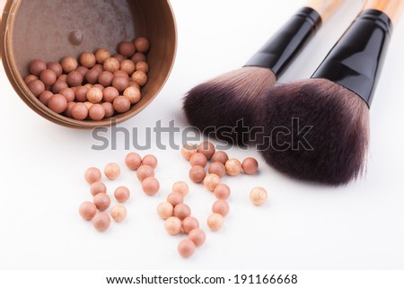 Bronze beads blush with makeup brush isolated on white