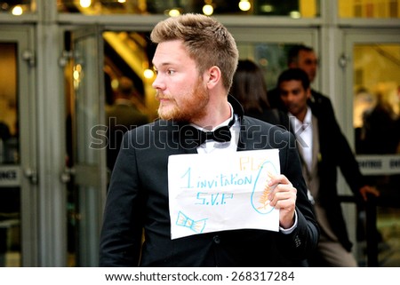 CANNES, FRANCE - MAY 22: Young man asking for a film invitation at the 67th edition of the Cannes Film Festival (2014).
