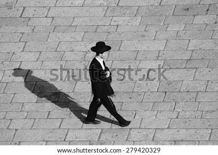 JERUSALEM, ISRAEL - NOV 21, 2013: young Jewish man walking in Jerusalem.