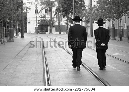 JERUSALEM, ISRAEL - NOV 23, 2013: Two Jewish man walking in the streets of Jerusalem.