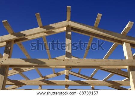 Wooden roof during the early stages of construction in a sunny day