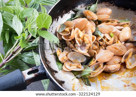 Clams fried chili in pan . Thai food