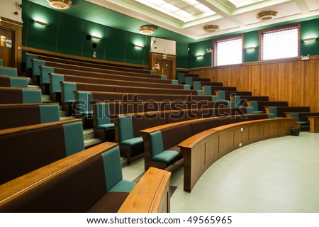 A wood panelled university lecture theatre/conference hall