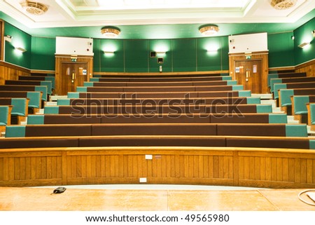 A wood panelled university lecture theatre/conference hall