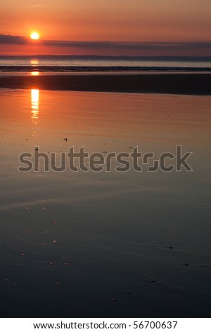 Brilliant sunset over a calm ocean in the summertime