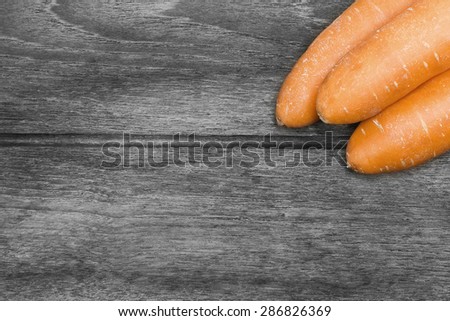 Carrots on black white wood background vintage style