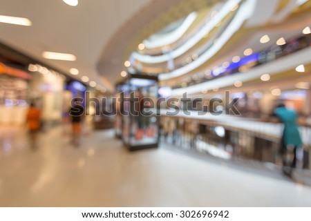 Blurred people go shopping in shopping mall in holiday summer sale business background
