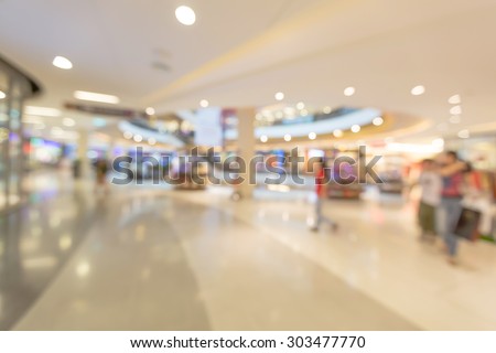 Blurred people walking to buy product in shopping mall in holiday summer