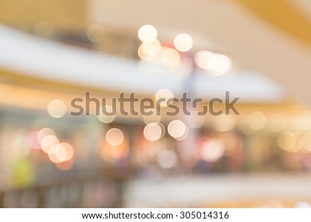 Blurry bokeh light in shopping mall for business blurry background