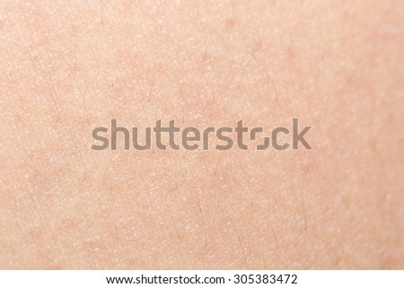 Soft focus human skin texture with black hairs for healthy texture background