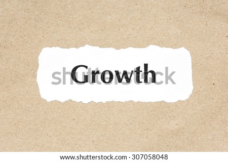 Growth word on white ripped paper on brown document texture